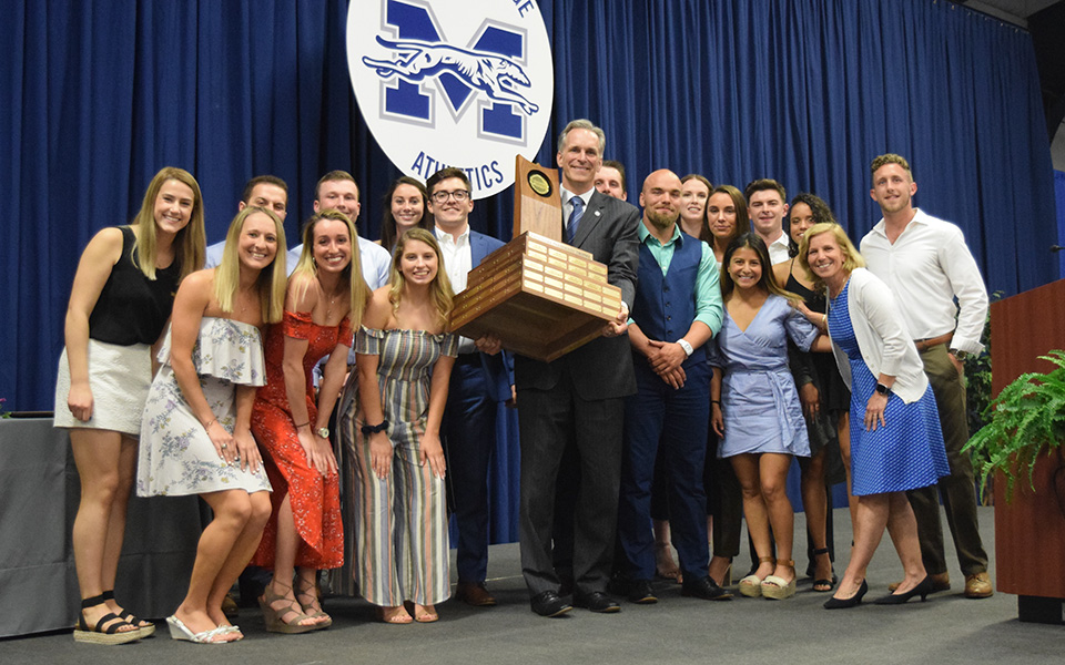 Senior student-athletes from each of the programs that compete in the Landmark Conference present the Presidents' Trophy to Moravian College President Bryon L. Grigsby '90 at the annual Senior Athletic Banquet on May 8 after the Greyhounds had clinched the trophy for a second straight year.