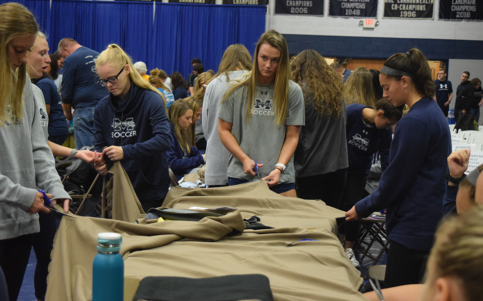 Members of the women's soccer team make blankets during Moravian's 4th Annual Heritage Day.