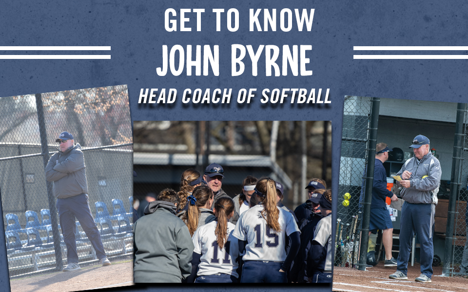 head softball coach john byrne with his team at blue and grey field.