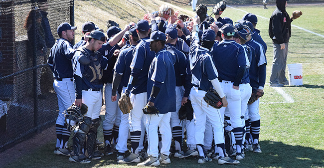 The Greyhounds huddle before the start of the series finale with Catholic University on Gillespie Field.