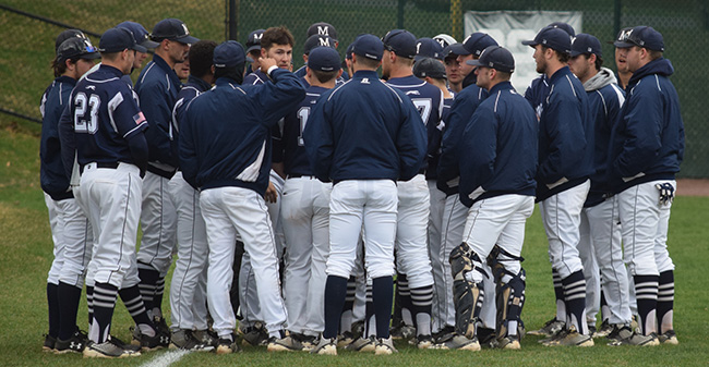 The Greyhounds talk in the outfield before a game versus Drew University at Gillespie Field.
