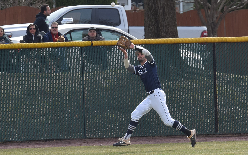 Senior Mike Mittl tracks down a fly ball in left field versus Elizabethtown College at Gillespie Field.