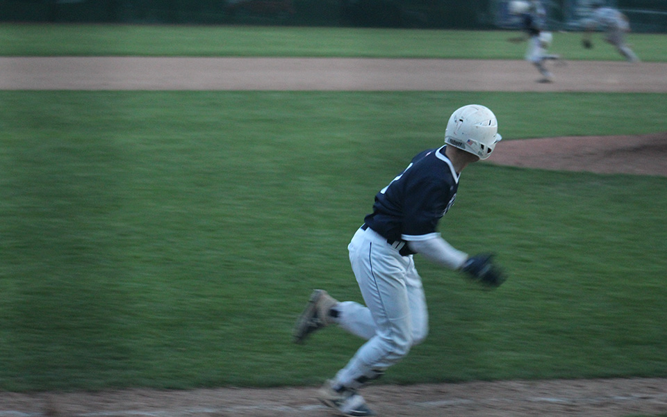 Freshman outfielder Robert Roman races towards first base as his two-RBI, walk-off single gets by the shortstop versus Messiah College at Gillespie Field.