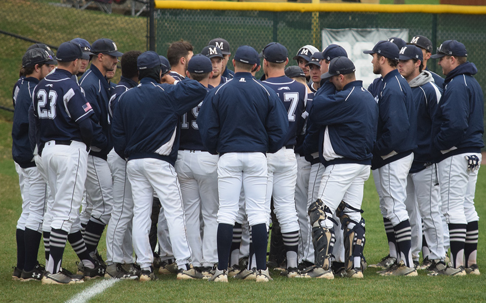 The Greyhounds talk in the outfield prior to a Landmark Conference game versus Drew University at Gillespie Field during the 2018 season.