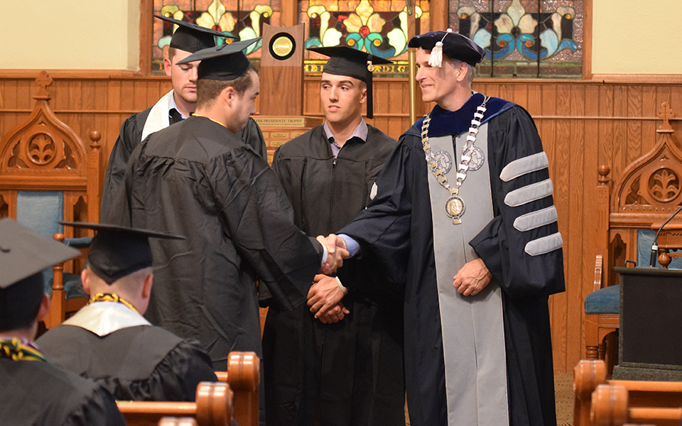 President Bryon L. Grigsby '90 at the 2018 baseball graduation ceremony in Borhek Chapel.