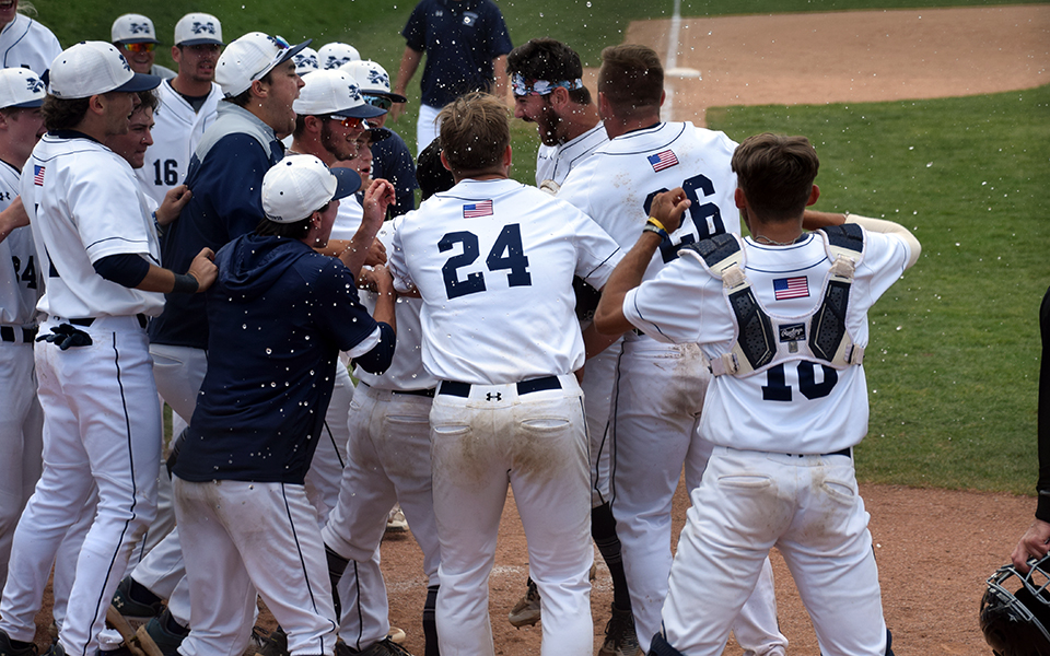 The Greyhounds celebrate Nick Henry's 12th inning walk-off homer to earn a split with The University of Scranton in the final two games of a Landmark Conference series at Gillespie Field. Photo by Marissa Williams '26