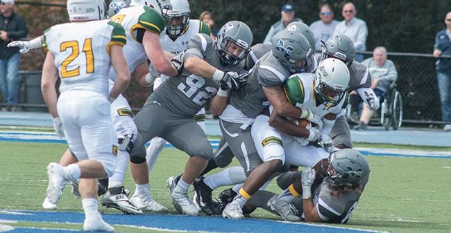 The Greyhounds' defense stops a McDaniel College running back in the 2017 home opener.