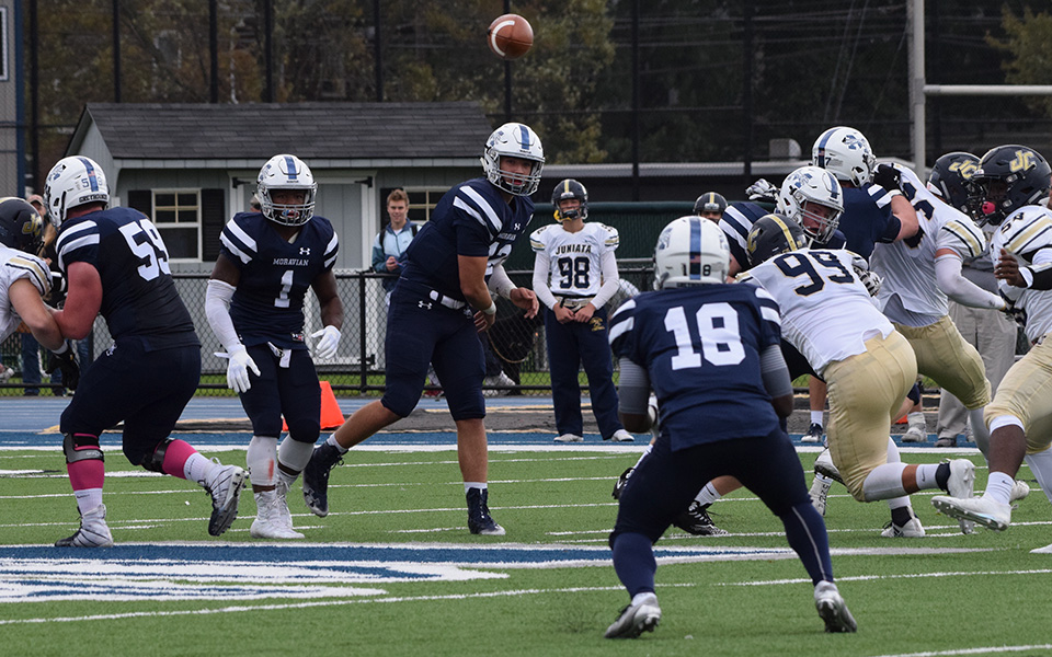Freshman quarterback Christopher Mills tosses a pass to freshman wide receiver Cory Little versus Juniata College.