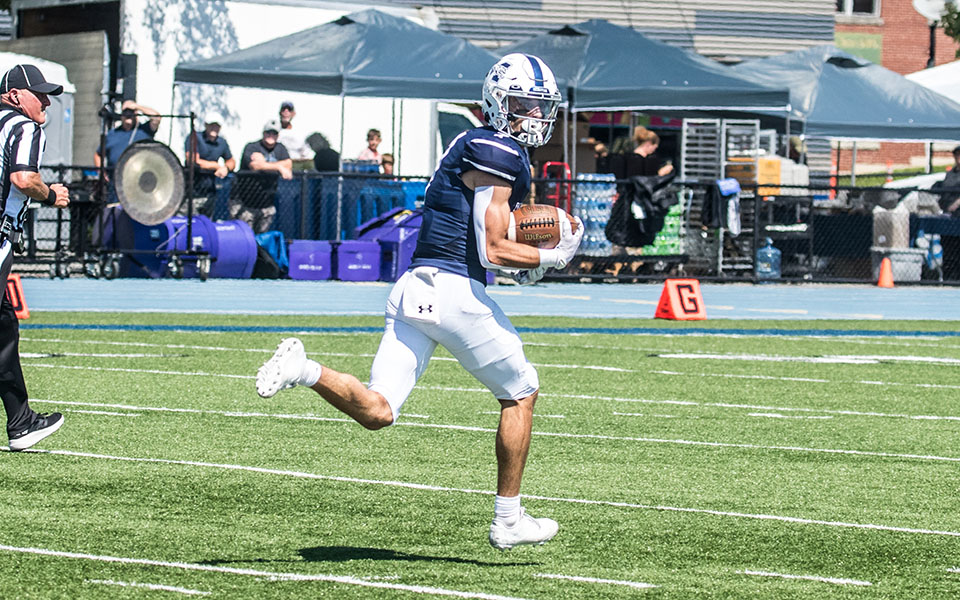 Junior wide receiver heads to the end zone with a long touchdown reception versus Gettysburg College at Rocco Calvo Field. Photo by Cosmic Fox Media / Matthew Levine '11