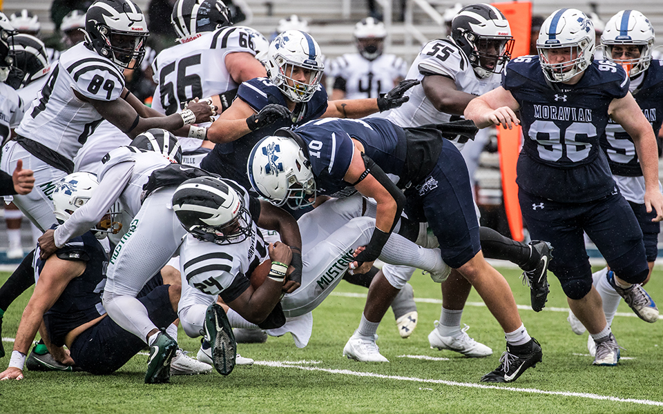 Sophomore linebacker Clay Basile makes a tackle at the line of scrimmage versus SUNY Morrisville at Rocco Calvo Field. Photo by Cosmic Fox Media / Matthew Levine '11