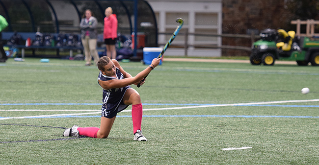 Olivia Schlofer '20 lifts a penalty stroke into the cage for a goal against Elizabethtown College.