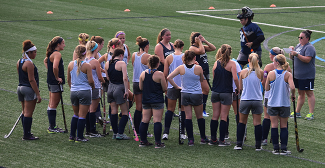 Head Coach Kristen Gillis talks with her squad on the opening day of preseason camp.
