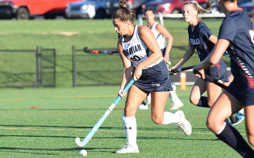 Ava Edwards heads up field with the ball on her stick in the 2021 season opener at DeSales University.