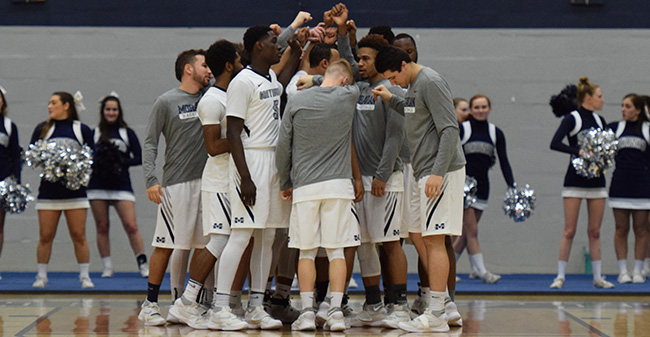 The Greyhounds huddle before a game versus The University of Scranton in February 2017.