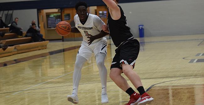 Oneil Holder '19 drives to the basket in the first half versus Bryn Athyn College.