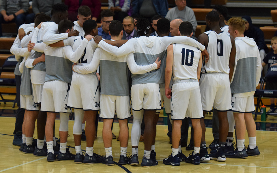 The Greyhounds huddle before tip-off of the 2018-19 home opener versus No. 15 Johns Hopkins University in Johnston Hall.