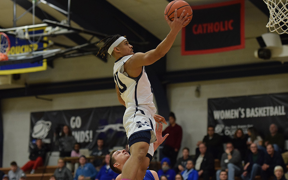 Junior C.J. Barnes goes up for a lay-up in the second half versus Goucher College in Johnston Hall.