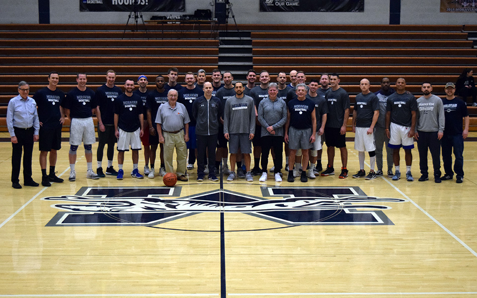 The former players, former coaches and current coaching staff before the 2019 Men's Basketball Alumni Game in Johnston Hall.
