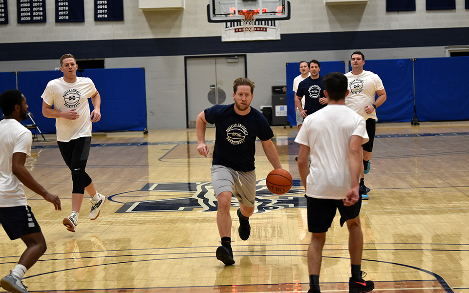 Ryan Miller '08 dribbles up the floor during the 2022 Alumni Game in Johnston Hall.