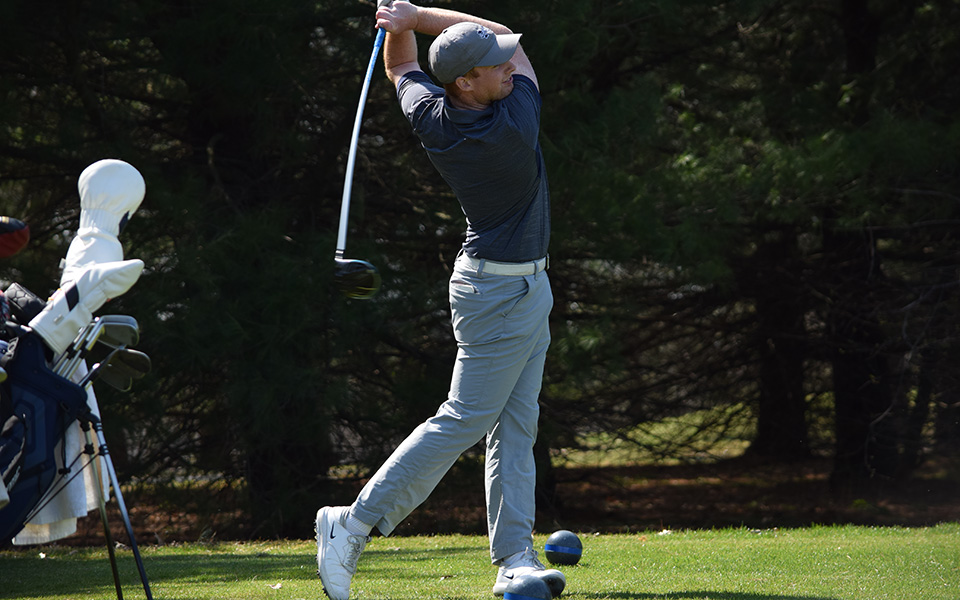 Junior Nick Kuhn watches a shot after teeing off during the Moravian Spring Invitational at Southmoore Golf Course.