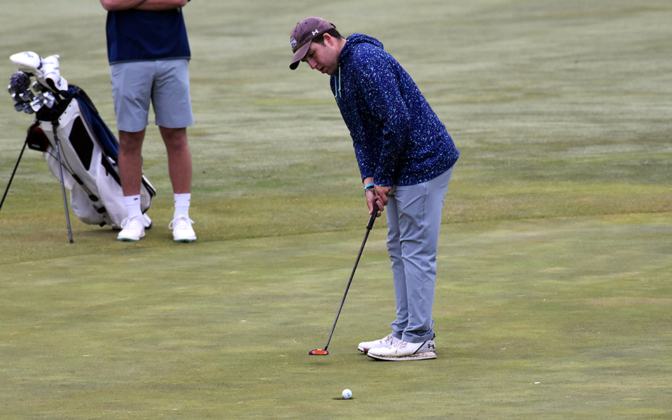 Sophomore Jason Koch drains a putt on the ninth green at Olde Homestead Golf Club to finish his round in the Moravian Spring Classic.