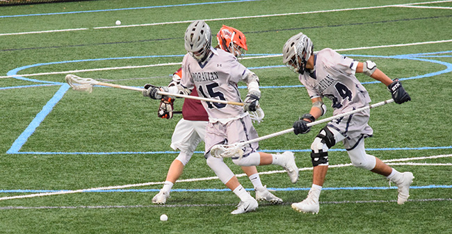 John Polich '19 and Tanner Leslie '21 go after a loose ball versus Susquehanna University in March 2018.