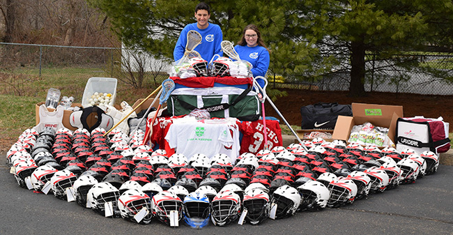 Moravian College freshman goalie Will Dadorius, President of ReLax Collections and Kaitlyn Sleyster, the Vice-President of ReLax, pose with the donations collected in 2016.