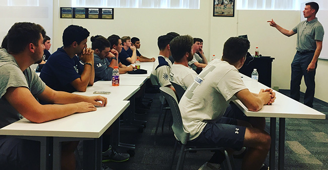 Captain Justin Bokmeyer speaks with the men's lacrosse squad about leadership skills in Johnston Hall.
