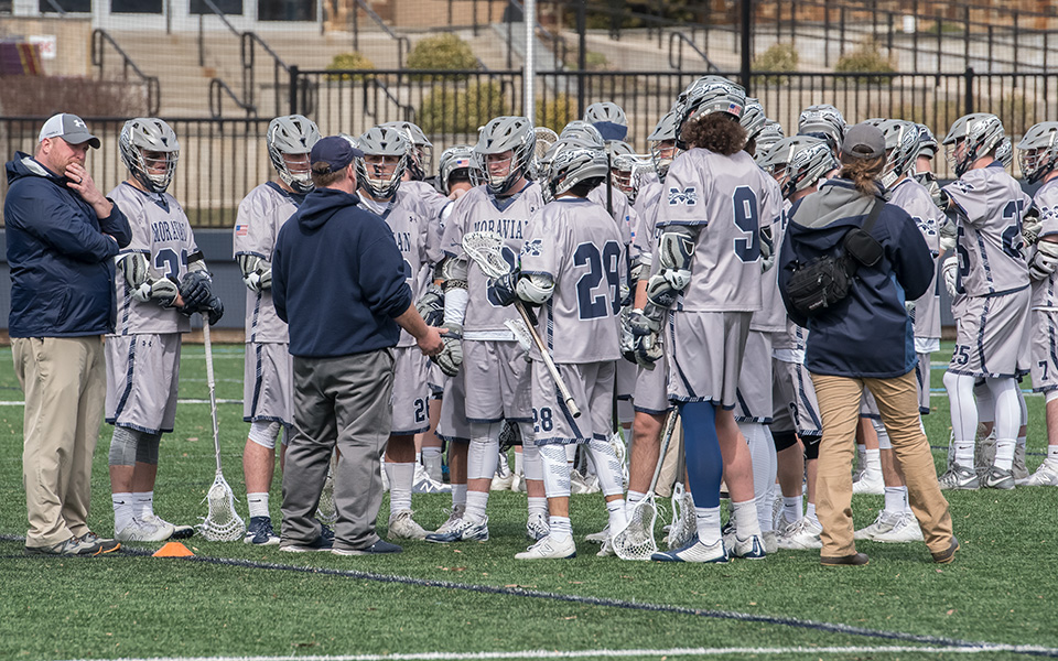 Head Coach Dave Carty talks with his team during a timeout in a match versus Muhlenberg College on John Makuvek Field during the 2018 season.
