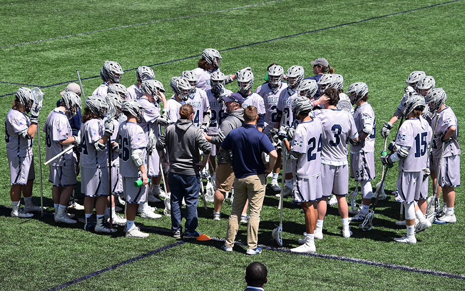 The Greyhounds talk during a time out versus The Catholic University of America on John Makuvek Field during the 2018 season.