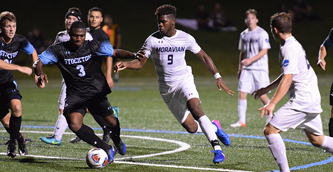 Dylan Evande '20, who scored the Greyhounds' first goal against NJCU, dribbles the ball in traffic against Stockton University earlier this season.