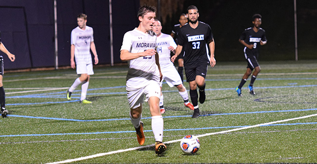 Michael Feeley '21 plays the ball in a match versus Berkeley (N.Y.) College.