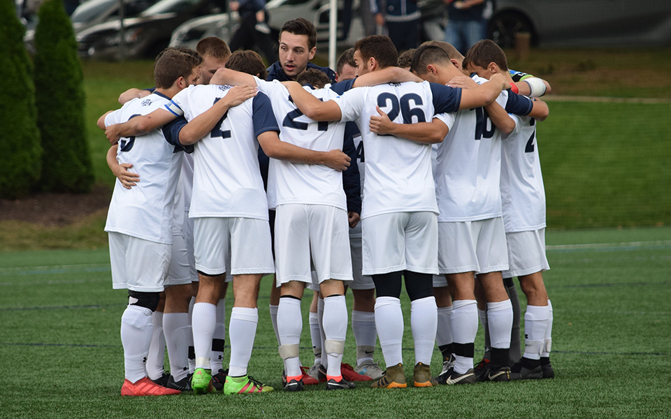 The Greyhounds huddle before the start of their Landmark Conference match versus The Catholic University of America on John Makuvek Field in October 2018.