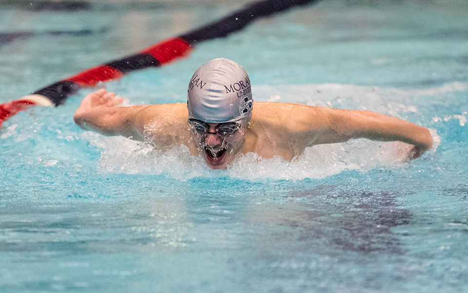 Freshman Evan Bulette swims in the 100-yard butterfly in a double dual meet with Goucher College and Susquehanna University at Liberty High School's Memorial Pool earlier this season. Photo by Cosmic Fox Media / Matthew Levine '11