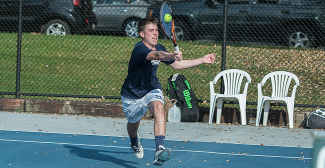 Peter Demyan '19 returns a shot during doubles action in a match versus DeSales University in the fall of 2017.