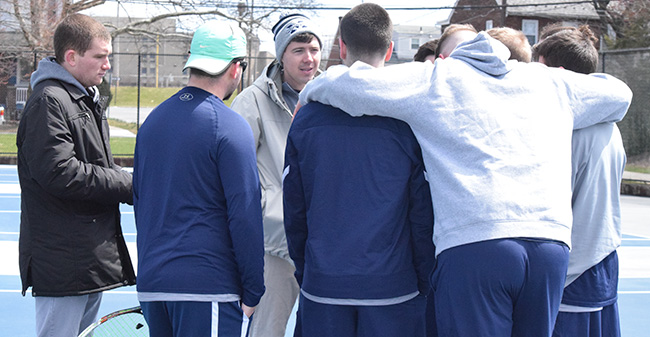 The Hounds huddle before the start of a match with Susquehanna University on Hoffman Courts.