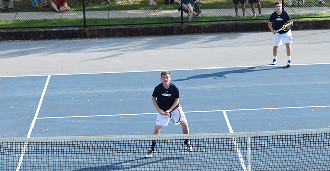Peter Demyan '19 and Isaac Schefer '19 await a serve in doubles action against DeSales University.