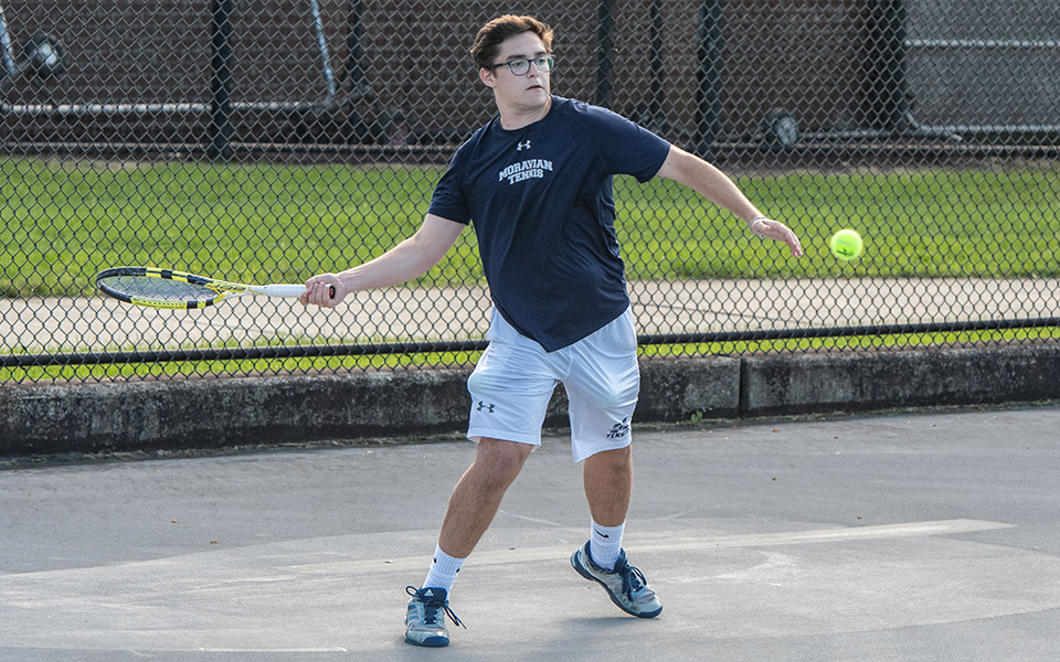 Senior Isaac Schefer returns a shot in doubles action versus FDU-Florham on Hoffman Courts during the fall 2018 season.
