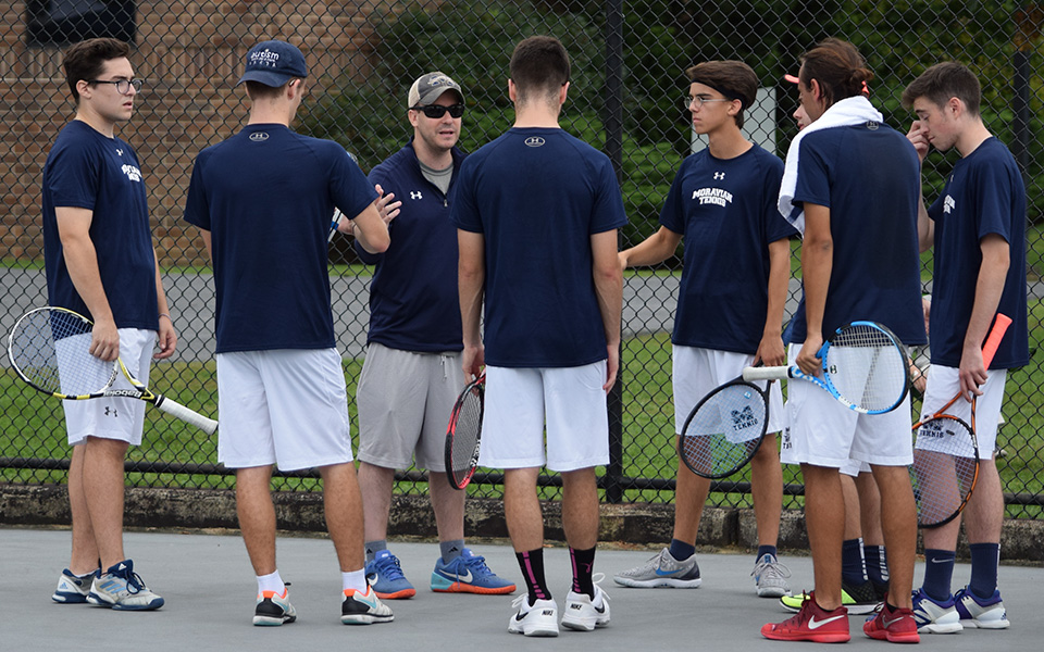 First-year Director of Tennis Aaron Wilf addresses the Greyhounds before the season-opener with Muhlenberg College at Hoffman Courts.