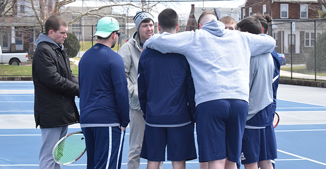 The Greyhounds talk before a match versus Susquehanna University in April 2018.