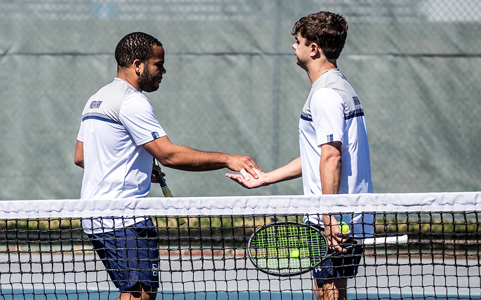 Sophomores Ronny Pimentel Ferrer and Wyatt Marshall after  winning a point in doubles action versus Goucher College at Hoffman Courts this spring. Photo by Cosmic Fox Media / Matthew Levine '11