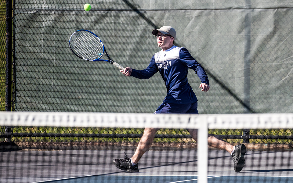 Senior Andrew Hozza tracks down a ball during singles action in a match versus Goucher College at Hoffman Courts earlier this season. Photo by Cosmic Fox Media / Matthew Levine '11