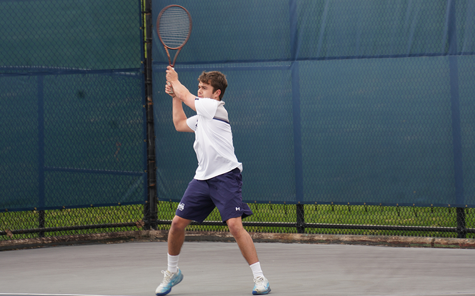 Junior Wyatt Marshall hits a backhand in a match versus Susquehanna University at Hoffman Courts. Photo by Avery Saladino '24