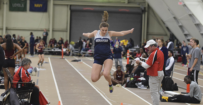 Jenevieve Eberly competing in the long jump.