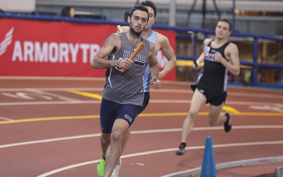 Senior Devon Harris runs the opening leg of the distance medley relay at the New York City Armory in the NYC Division III Invitational. Photo courtesy of Eastern University Athletic Communications.