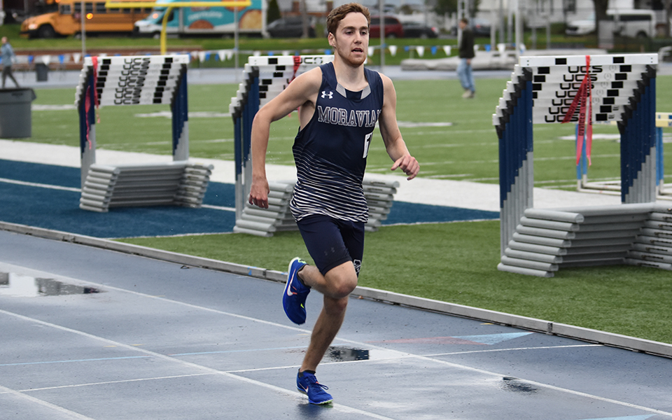 Junior Nathan Hajel comes to the finish line in the 10,000-meter run on the first day of the 2024 Coach Pollard Invitational at Timothy Breidegam Track.