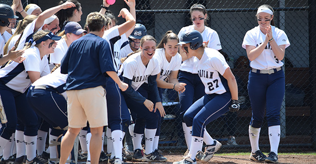The Greyhounds celebrate Brooke Wehr's first inning home run in the opening game versus The University of Scranton at Blue & Grey Field.