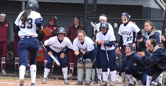 The Greyhounds wait at home plate for Madison Shaneberger '19 after a home run in the first game versus Susquehanna University at Blue & Grey Field.