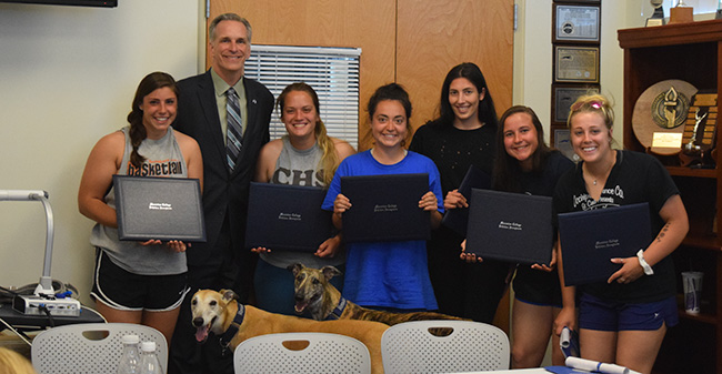 Josie Novak, Janae Matos, Jackie Marshall, Amanda Carisone, Jean Markovic & Megan Taylor with President Bryon L. Grigsby '90, Mo and Benny after receiving their Moravian degrees.