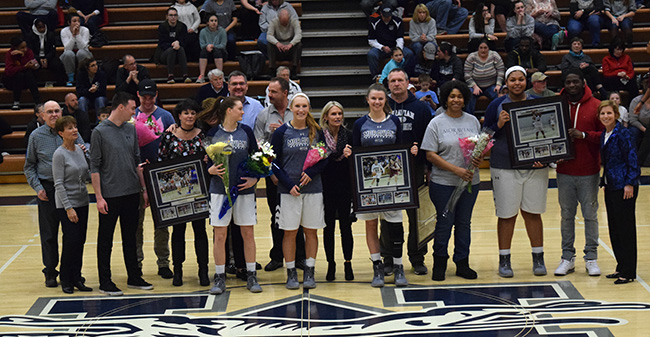 Seniors Taylor Freeman, Trista Cunningham, Jen Cella and Ciara Stewart with their families and Head Coach Mary Beth Spirk on Senior Day.